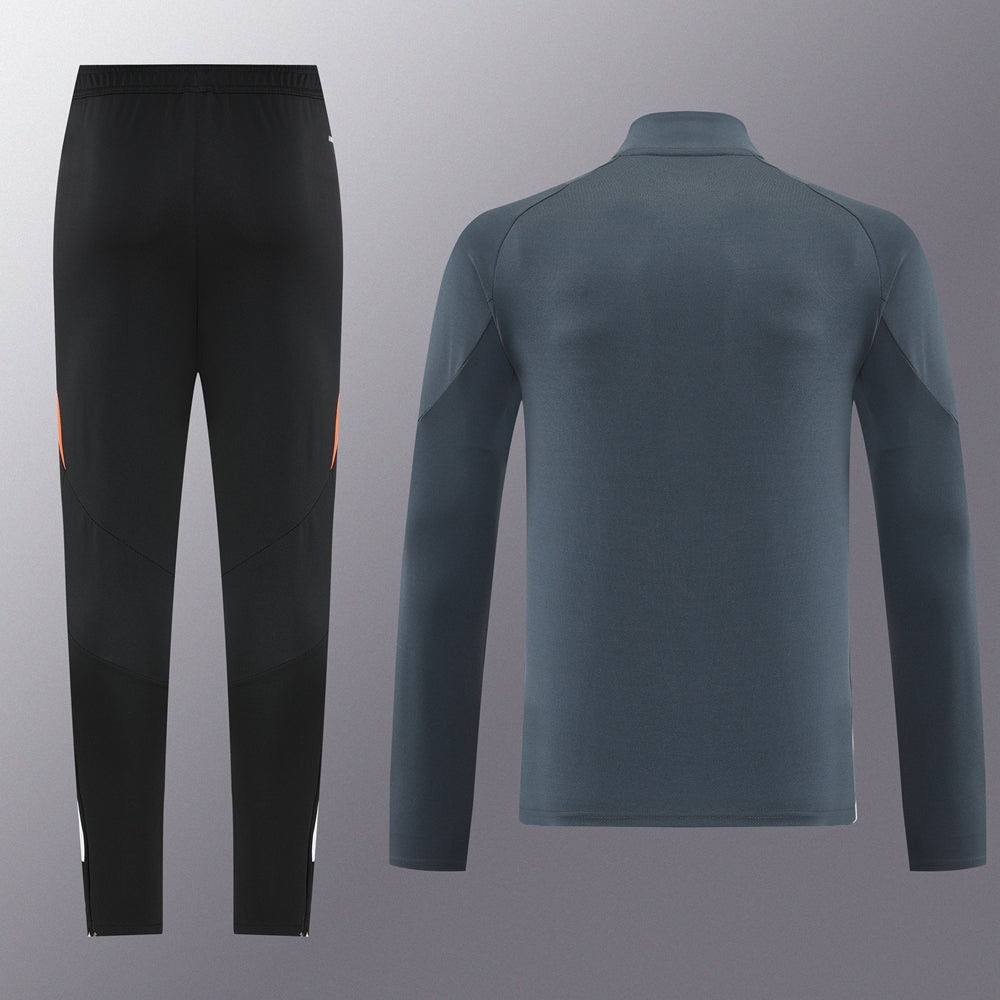 fa9c8bc4 | UAE SPORT STORE Black athletic pants with orange side accents paired with a blue long-sleeve training top