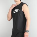 Person wearing a black sleeveless Nike athletic top, touching the collar with a watch on the left wrist