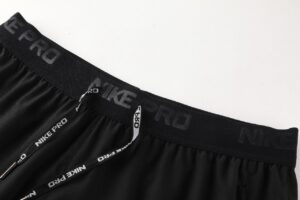 Black Nike Pro athletic shorts showing an elastic waistband with a branded drawstring reading 'NIKE PRO' repeatedly.