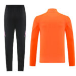 Orange long-sleeve athletic top and black tapered pants with pink accents, shown from the back.