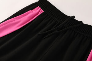 Black athletic shorts with a bright pink side stripe and a black drawstring at the elastic waistband.