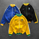 Three Brazil football track jackets in blue, yellow, and black with Nike swoosh and crest on a gray background.
