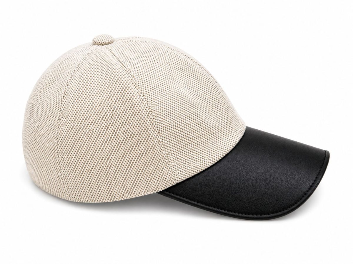 Beige woven cap with a black leather curved brim, shown on a white background.