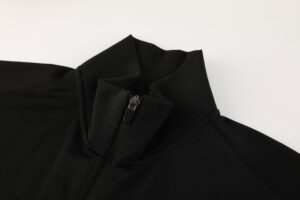 fc553142 | UAE SPORT STORE Close-up of a black jacket collar with a metal zipper pull visible