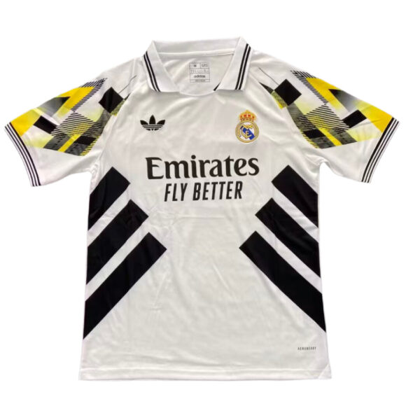 White Real Madrid Adidas football jersey with black geometric chevrons on the sleeves and sides, crest and 'Emirates Fly Better' sponsor text on front.