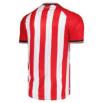 Back view of a red and white vertical striped soccer jersey with short sleeves and black-and-white trim at the cuffs.