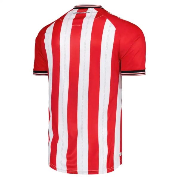 Back view of a red and white vertical striped soccer jersey with short sleeves and black-and-white trim at the cuffs.