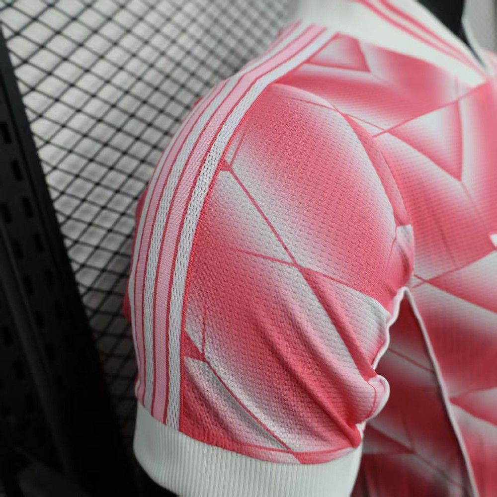 fd11d94a-ff37-4b03-9c09-391a6e0757bc | UAE SPORT STORE Pink athletic jersey sleeve with geometric white pattern and white cuff, close-up view on the shoulder area
