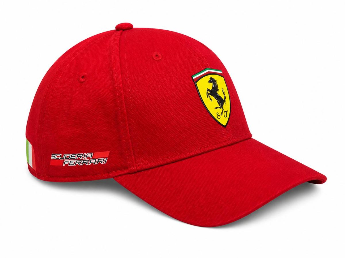 Red Ferrari cap with a yellow shield logo featuring the black prancing horse on the front and 'Scuderia Ferrari' text on the side.