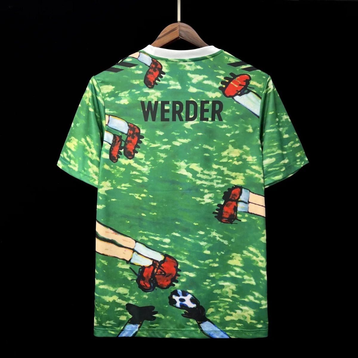Green camouflage-pattern T-shirt on a hanger with cartoon limbs print and the word 'WERDER' on the back.