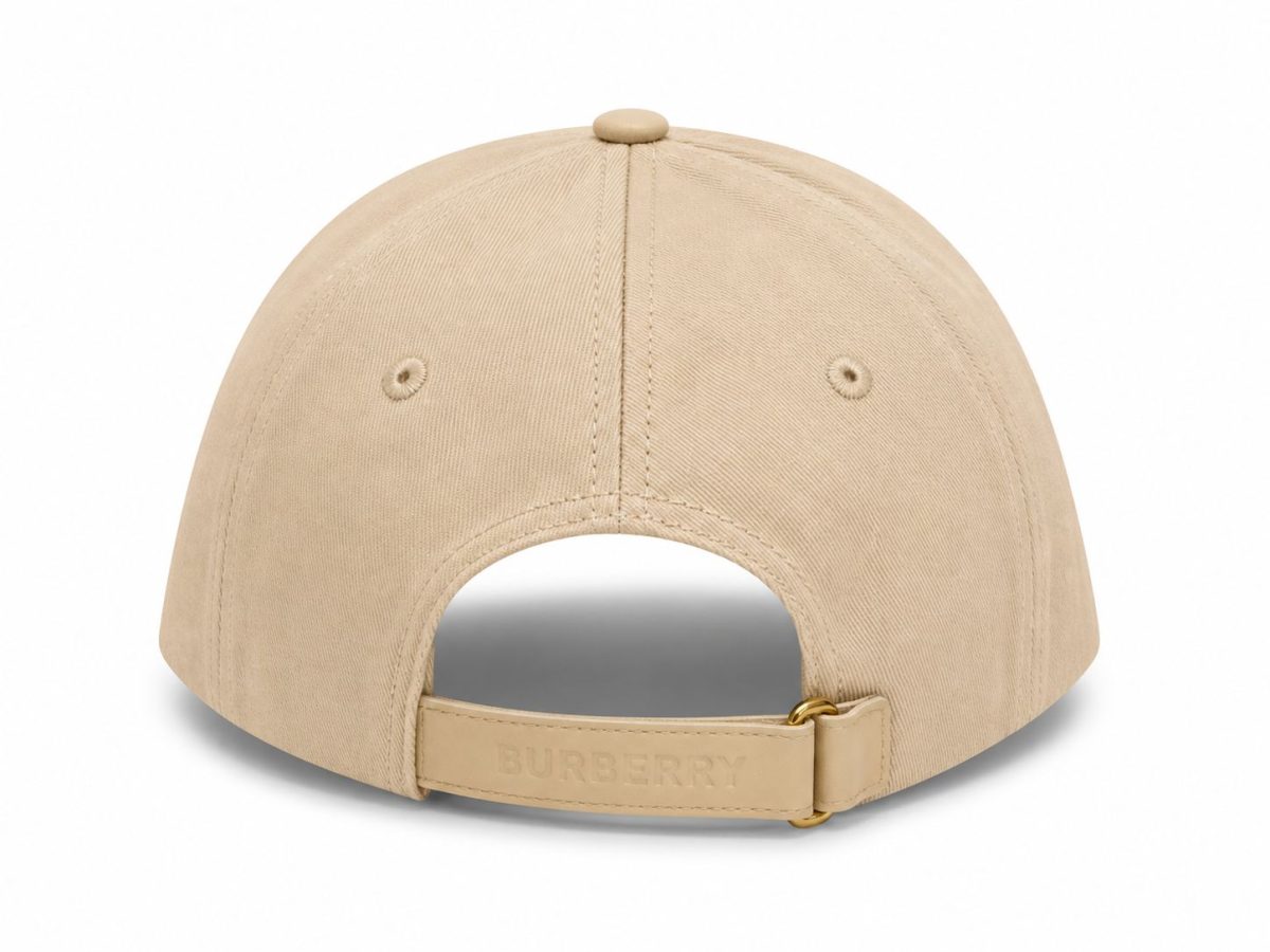 Back view of a beige baseball cap with an adjustable strap and a Burberry-branded leather strap closure.