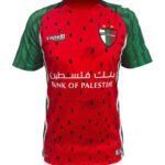 go22i6RvnTp3hhL | UAE SPORT STORE Red football jersey with green sleeves and side panels, featuring Bank of Palestine sponsor text across the chest and a Palestine crest on the left.