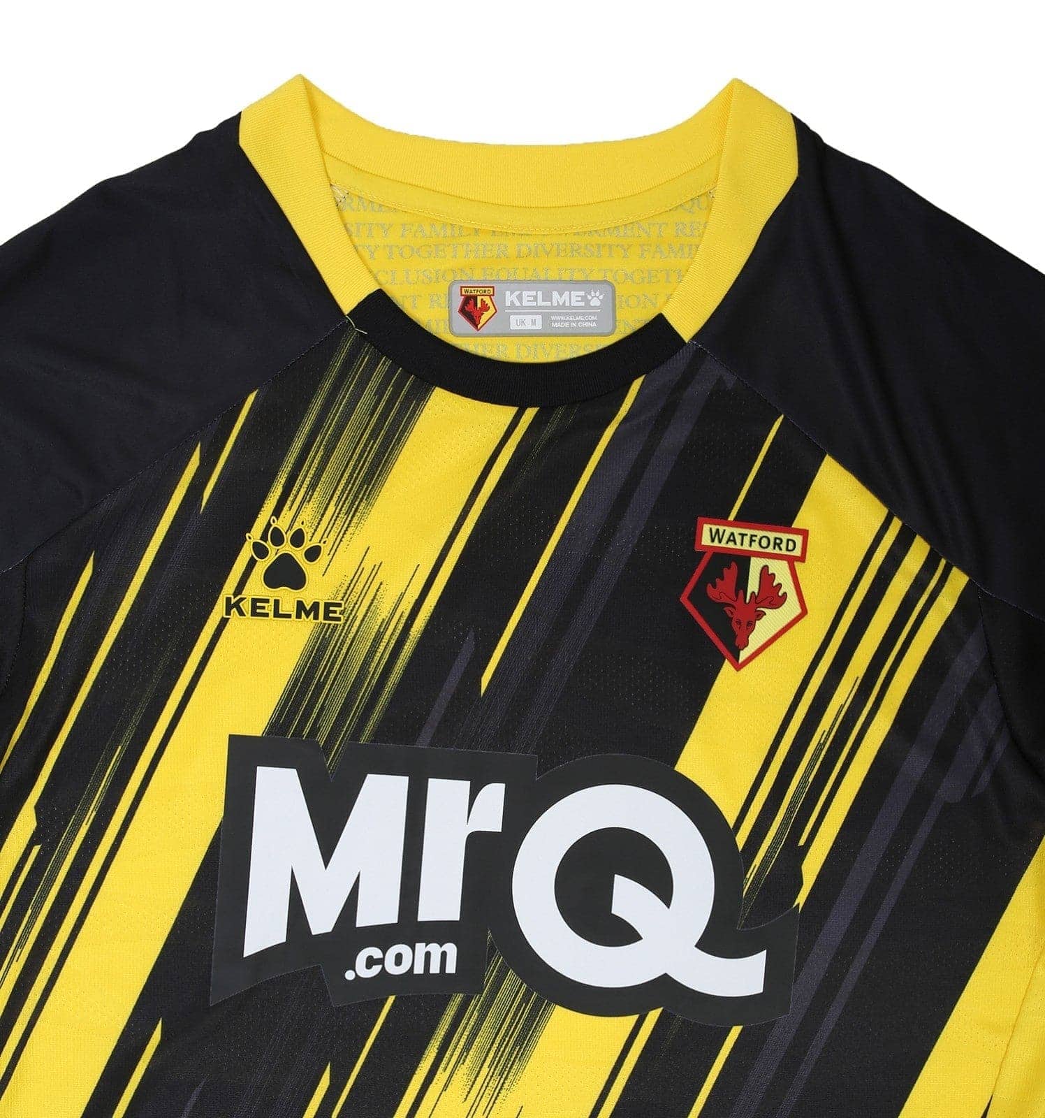 hV2F1l2j64zdO9J_4b94d7da-515a-4fe7-85d4-bde295ec3b6b | UAE SPORT STORE Close-up of a Watford FC jersey showing the club crest, Kelme logo, yellow collar, and bold black-and-yellow diagonal stripes with the MrQ sponsor text partially visible.