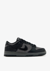 Black and gray low-top Nike sneaker shown from the side (side profile).