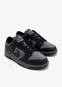 Grey and black Nike sneakers with perforated toe and matching midsole on a white background (pair shown)