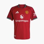 Manchester United red football jersey with Snapdragon sponsor, Adidas logo, and club crest with black-white trim at collar and sleeves.