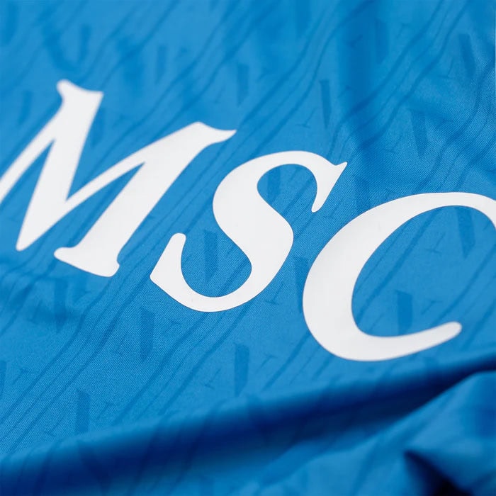 home-shirt-replica-1600-x-1600-px_06 | UAE SPORT STORE Close-up of blue fabric with the white letters 'MSC' printed across it.