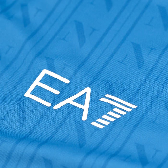 home-shirt-replica-1600-x-1600-px_10 | UAE SPORT STORE Close-up of blue fabric showing a white stylized 'EA' logo.