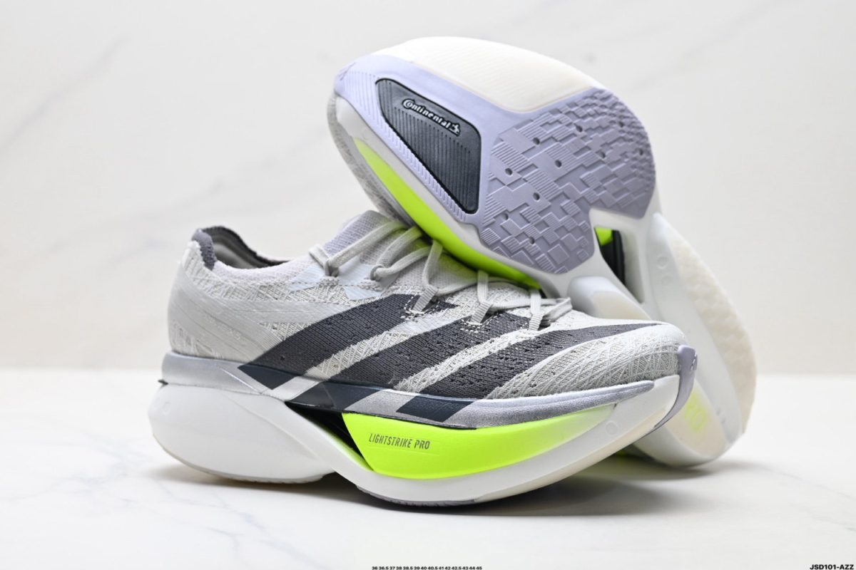 Close-up of two gray athletic shoes stacked together, highlighting a neon-yellow midsole labeled LIGHTSTRIKE PRO and textured gray outsole details