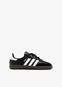 Black Adidas Samba sneaker with white 3 stripes and brown sole, side view.
