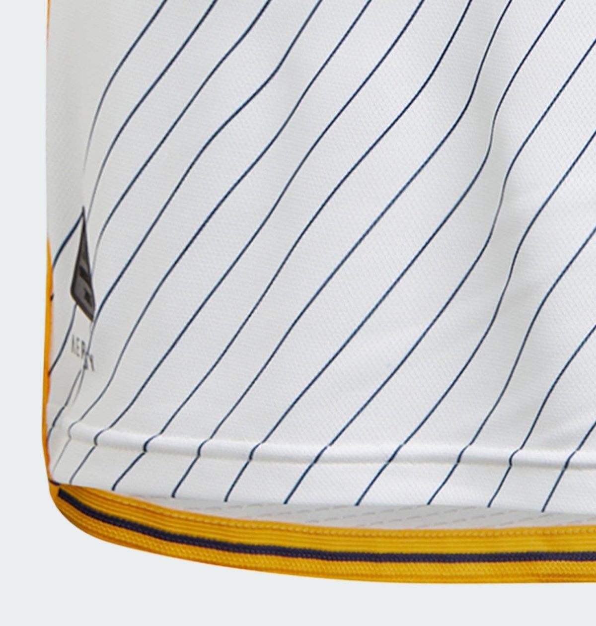 Close-up of white fabric with dark blue diagonal pinstripes and an orange-yellow edge trim along the bottom edge, showing curved seam detail.