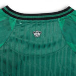 iklo | UAE SPORT STORE Green athletic jersey back neckline with a black-green striped collar and a small white bee emblem at the center of the collar area.