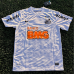 White soccer jersey laid flat on grass with orange Banco BMG sponsor, black team crest on the left chest, and Nike swoosh; NETSHOES printed on both sleeves; tag attached at neck edge.