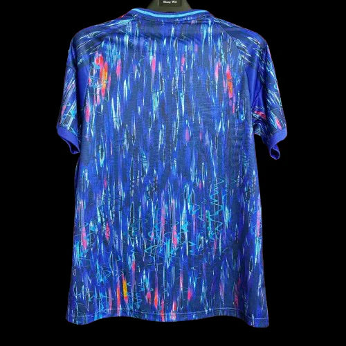 Blue athletic T-shirt with neon teal, pink, and yellow abstract streak pattern on a black background.