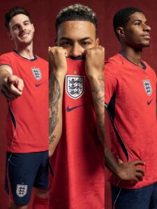 images_voltaxMediaLibrary_mmsport_si_01kmdvgcc3a8r3j1q5md | UAE SPORT STORE Three England football players in red jerseys pose against a red backdrop, the crest visible on their shirts.