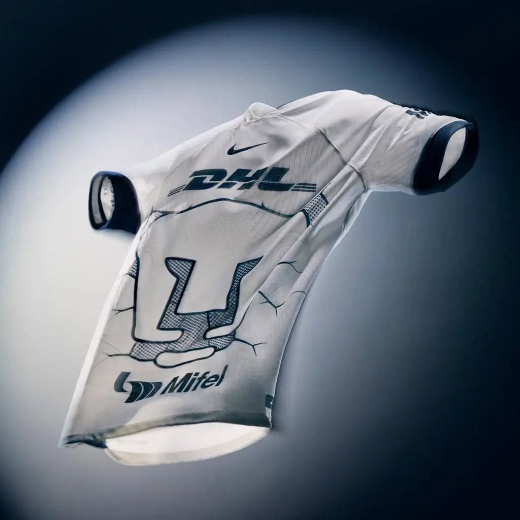 img_0299-1024x1024_dada631f-5302-4f25-97d9-8447a3bdb120 | UAE SPORT STORE White sports jersey with DHL logo and large number 11 flaring in midair against a dark background, billowing dynamically.
