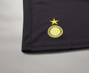 inter_97_Third_2 | UAE SPORT STORE Close-up of a dark sports jersey hem with the yellow Inter Milan crest and star above it