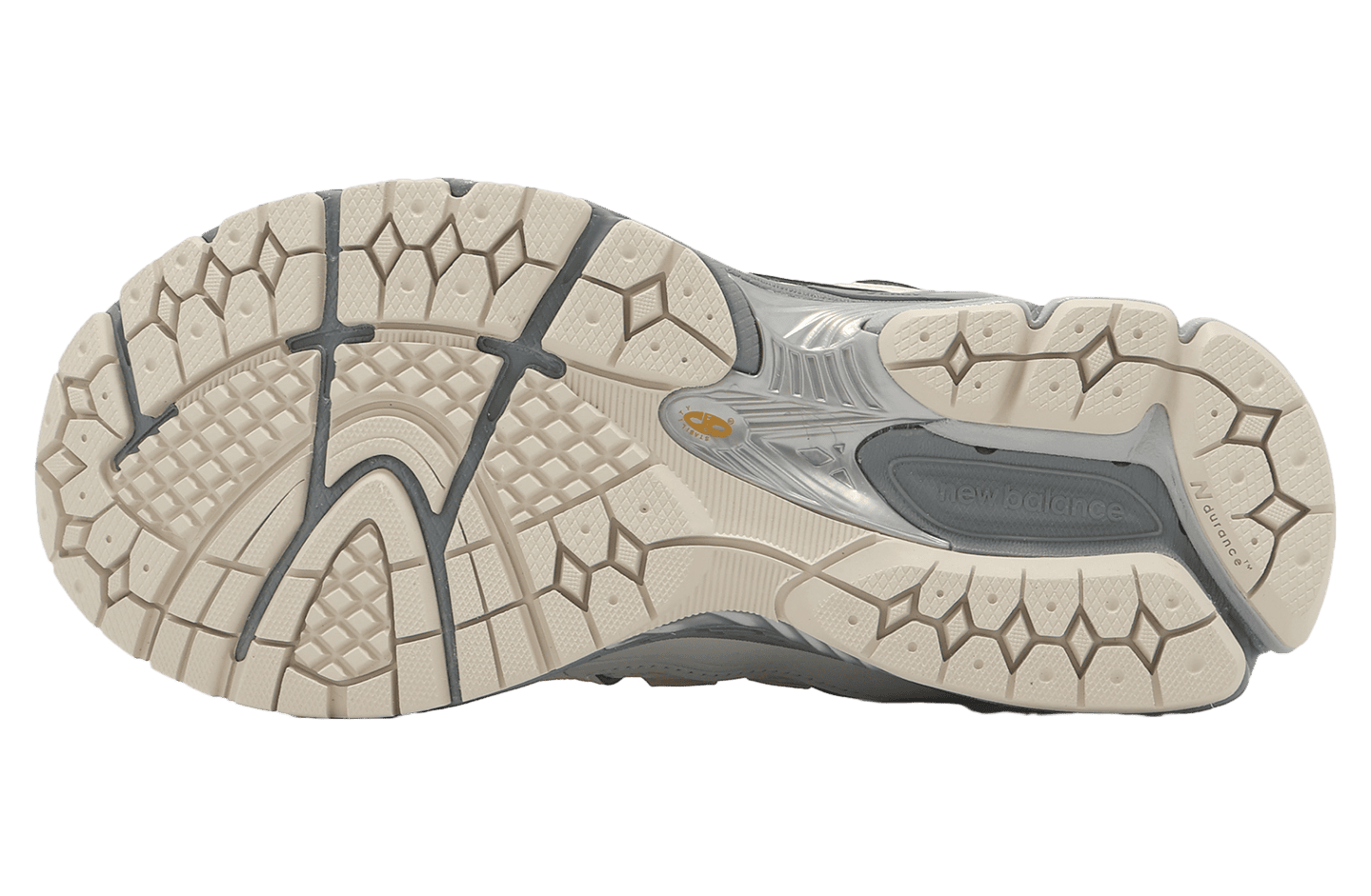 ipad_new-balance-1906r-beige-black-2 | UAE SPORT STORE Bottom view of a cream New Balance running shoe outsole with intricate hexagonal and grid tread patterns and gray midfoot insert.