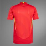 Back view of a red athletic jersey with yellow side panels and a small emblem at the collar area.