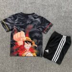 Kids' outfit: black T-shirt with Luffy punching forward from One Piece, paired with black shorts with white stripes on the sides.