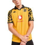 Male model wearing a yellow Kaizer Chiefs soccer jersey with Vodacom sponsor and black collar/sleeves.