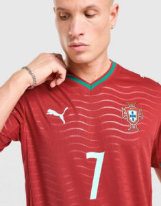 jd_778217_d | UAE SPORT STORE Portrait of a man wearing a red Portugal soccer jersey with a white number 7, Puma logo, and national crest on the chest.