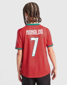 Child wearing a red Ronaldo #7 jersey, viewed from behind, with green trim on sleeves and collar.