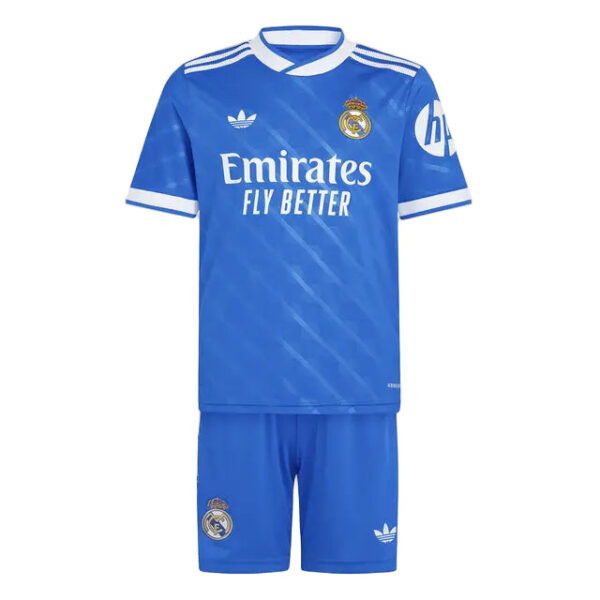 Real Madrid blue away football jersey and matching shorts, with Emirates Fly Better sponsor, club crest, and Adidas logos.