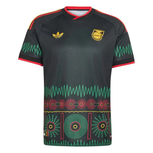 Black soccer jersey with red trim and a gold logo on the left chest, a crest on the right chest, and teal zigzag bands with circular motifs across the bottom of the shirt.
