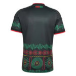 Back view of a black athletic jersey with red trim on the sleeves and collar, teal zigzag accents, and a colorful geometric pattern near the bottom hem.
