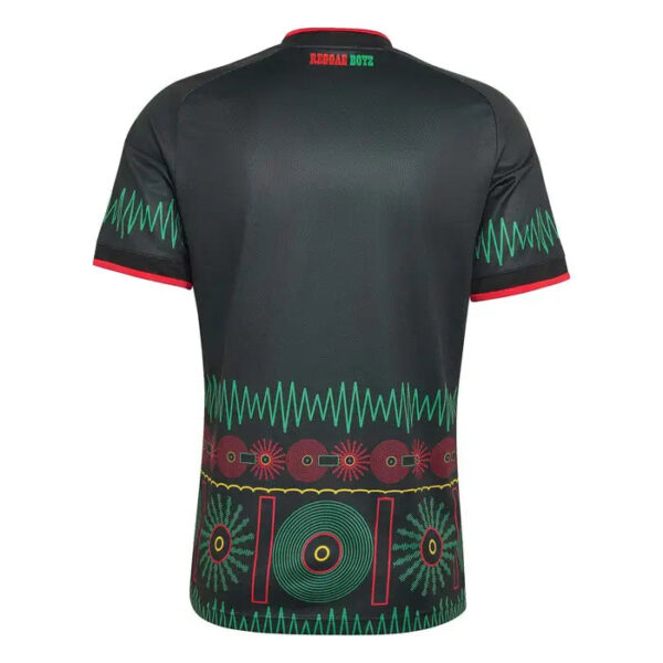 Back view of a black athletic jersey with red trim on the sleeves and collar, teal zigzag accents, and a colorful geometric pattern near the bottom hem.