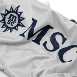 kd_d5de8ea9-1fc5-42ff-8dde-ae4a1b69fd9f | UAE SPORT STORE Close-up of white fabric featuring a navy MSC logo and large 'MSC' lettering.