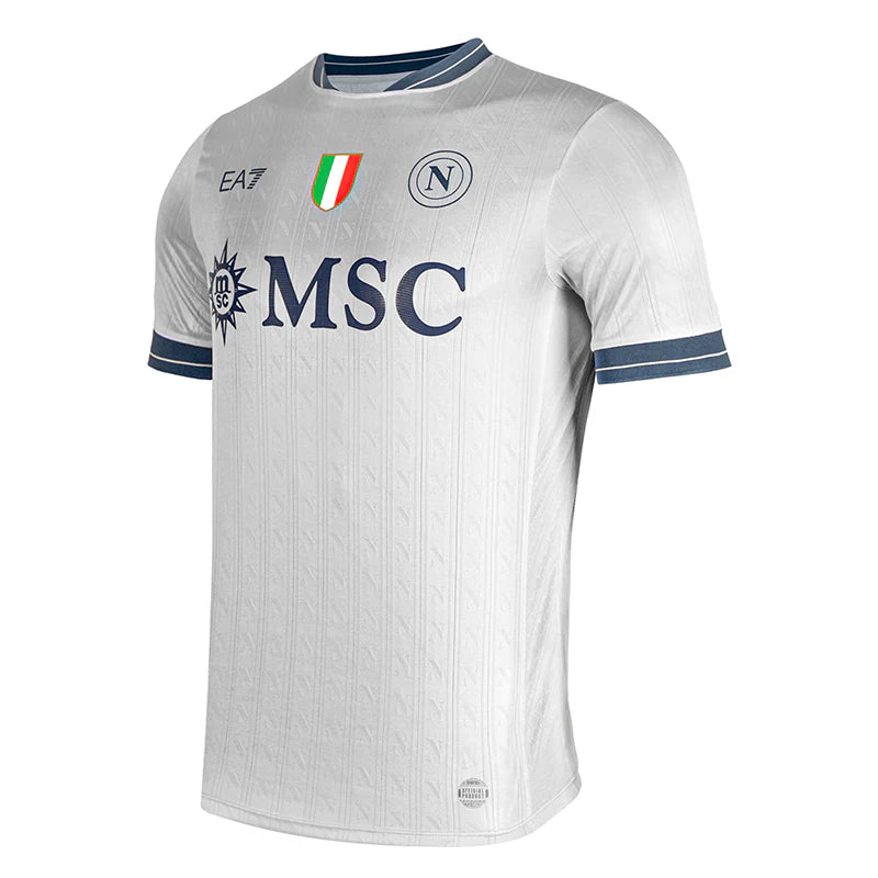 kg_d018899f-5e66-4a71-a852-9a07aff03bf4 | UAE SPORT STORE White soccer jersey with blue trim on sleeves and collar, featuring MSC sponsor logo and team crests, including an Italian flag emblem on the chest.
