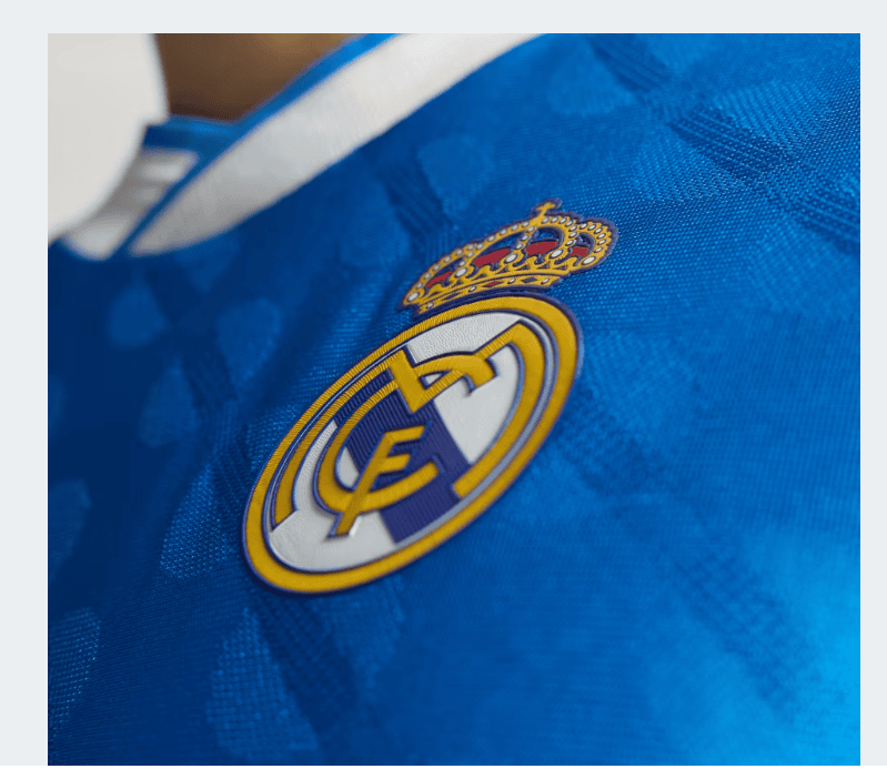 kllll | UAE SPORT STORE Close-up of a blue jersey with the Real Madrid crest and crown.