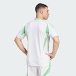 Model wearing white athletic kit with mint green accents, shown from the back with hands on hips