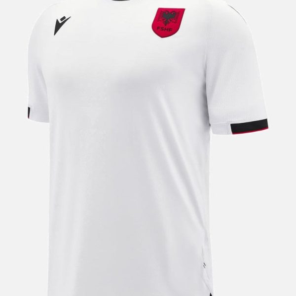 White athletic jersey with a red shield crest on the chest and black trim at the collar and cuffs, short sleeves.