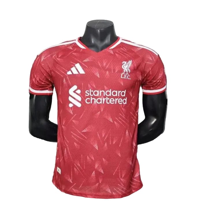 liverpool-2526-leaked-home-shirt-696x696-1 Front view of a red Liverpool FC jersey on a mannequin, with the Standard Chartered sponsor across the chest and club crest on the left.