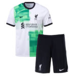 liverpool-away-kit-kids-202324-359597_433c001e-7477-40d0-b0fd-a587b9abafd4 | UAE SPORT STORE Liverpool FC away kit: white jersey with green geometric blocks, navy collar and sleeve cuffs, Standard Chartered sponsor logo, and LFC crest; navy shorts with club crest and white Nike swoosh.
