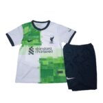 liverpool-away-kit-kids-202324-584873_abf0e4cb-d2c9-49da-bad0-a8f28360e697 | UAE SPORT STORE Liverpool FC away kit: white shirt with green geometric blocks, navy trim, sponsor Standard Chartered, and matching navy shorts.