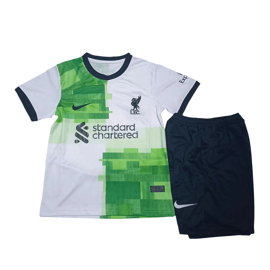 liverpool-away-kit-kids-202324-584873_abf0e4cb-d2c9-49da-bad0-a8f28360e697 | UAE SPORT STORE Liverpool FC away kit: white shirt with green geometric blocks, navy trim, sponsor Standard Chartered, and matching navy shorts.